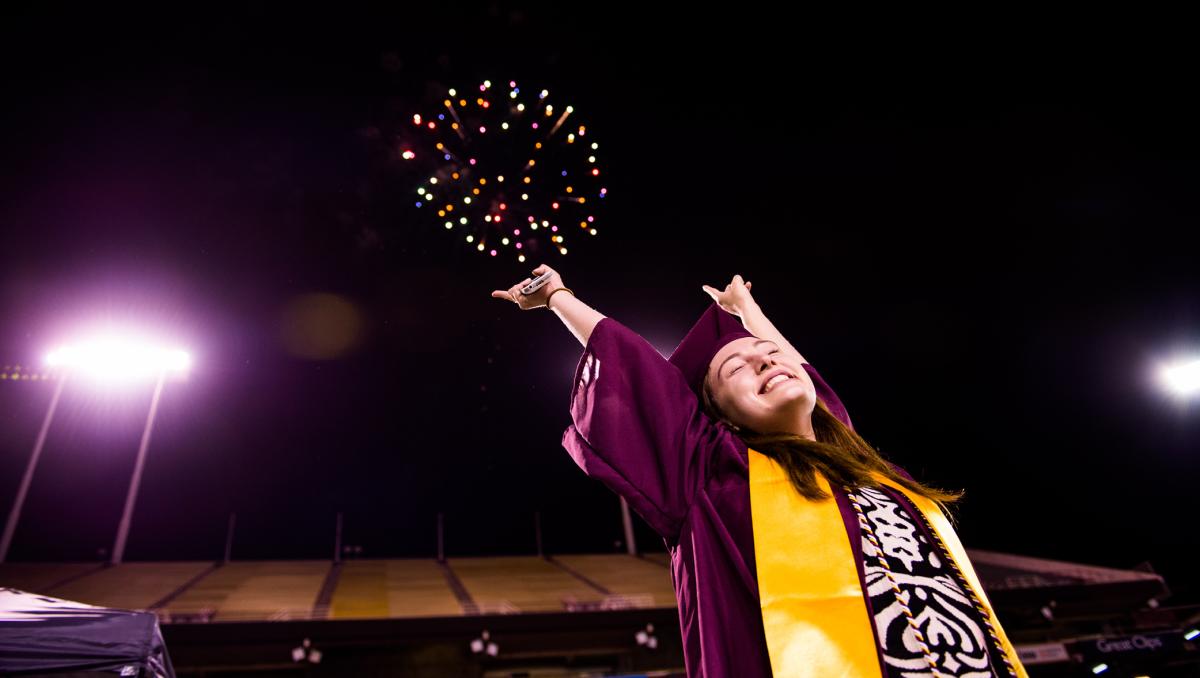 ASU graduate with fireworks